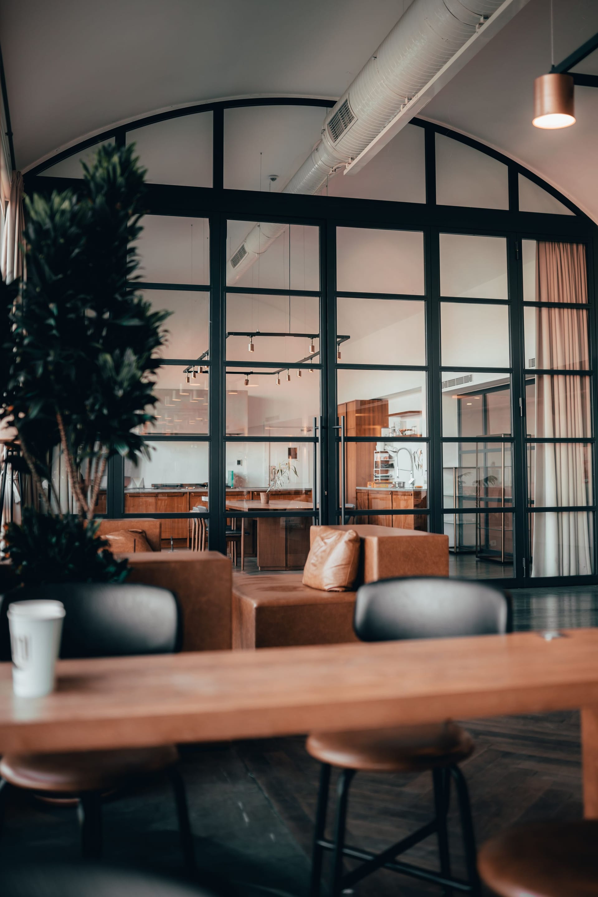 Office breakout space with glass partitions and leather seating